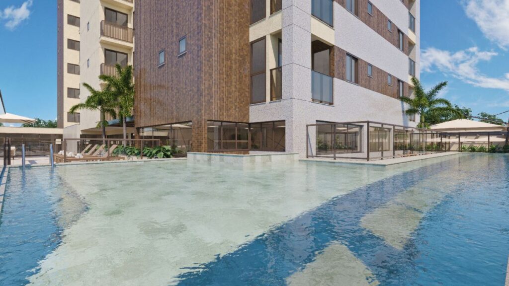 Área de lazer externa do Residencial Unité em Águas Claras, com piscina de águas claras, deck com espreguiçadeiras e fachada moderna ao fundo.