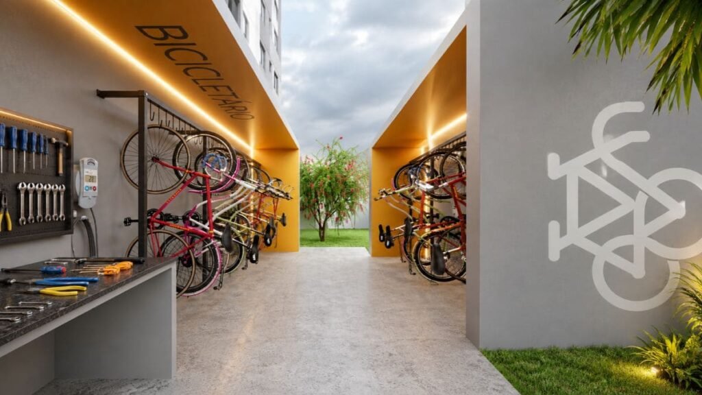 Bicicletário coberto e iluminado com suportes organizados e bancada de ferramentas no condomínio Nexus Taguatinga